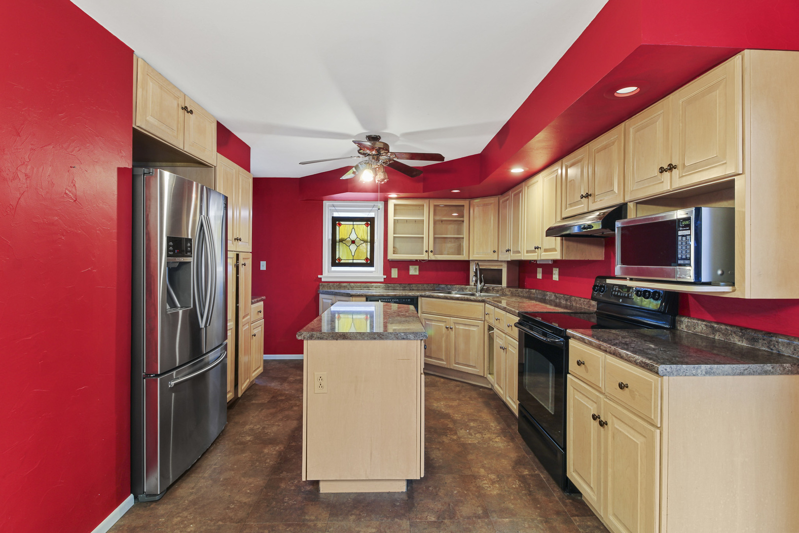 1208 West William Street Champaign, IL 61821 - Photo 5 of 30 a kitchen that has a lot of cabinets in it
