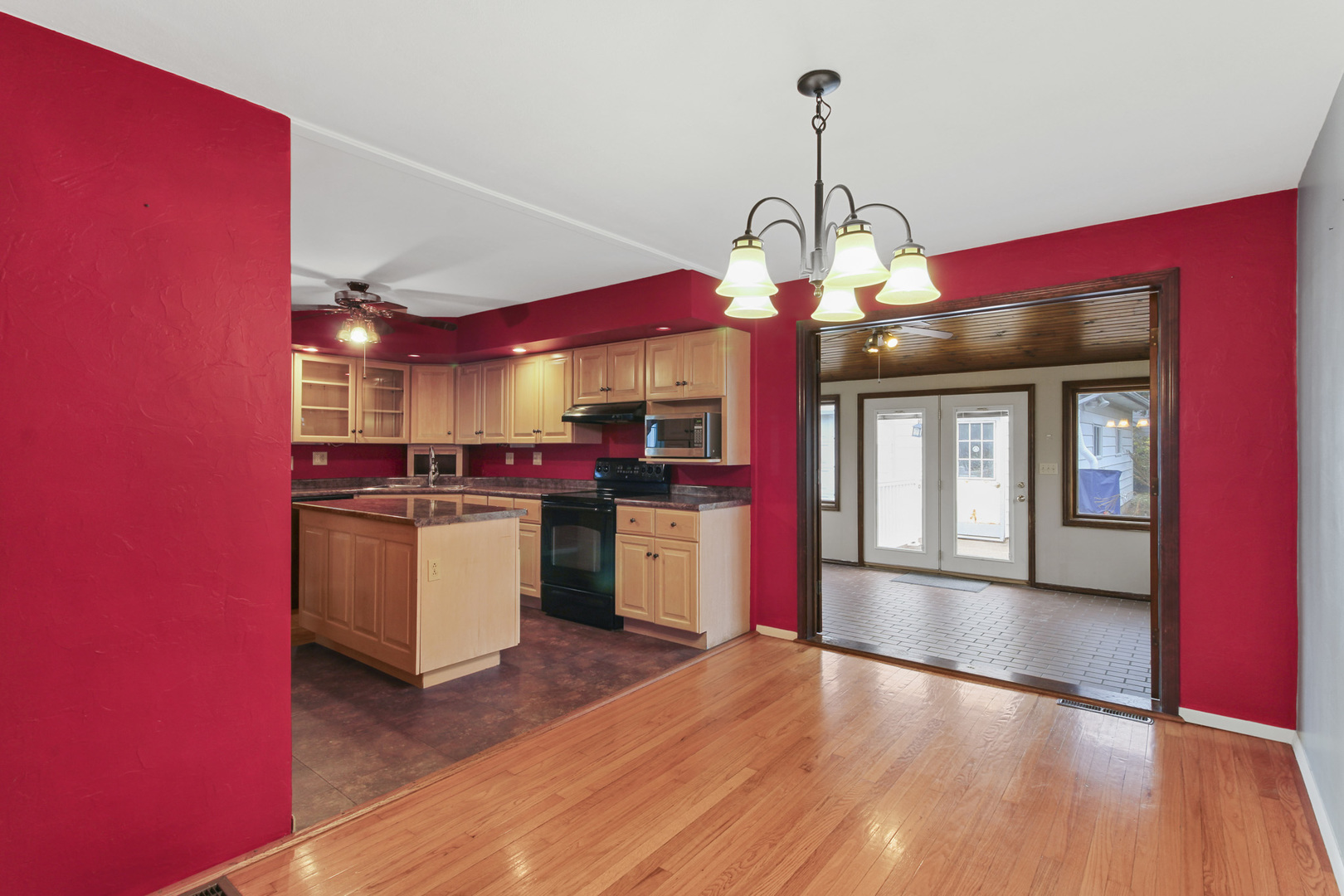 1208 West William Street Champaign, IL 61821 - Photo 6 of 30 a view of a kitchen with granite countertop a stove top oven a sink and dishwasher with wooden floor