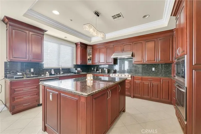 a kitchen with stainless steel appliances granite countertop sink stove and refrigerator