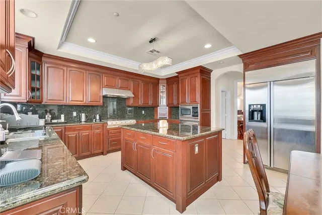 a kitchen with stainless steel appliances granite countertop a sink and cabinets