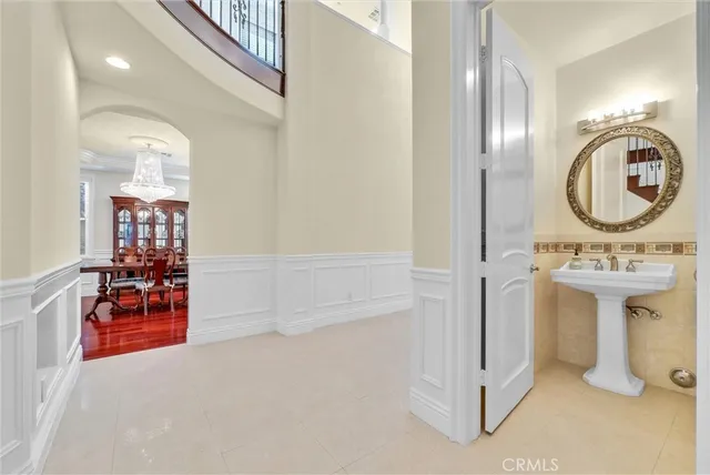 a view of staircase with lots of frames on wall and a window