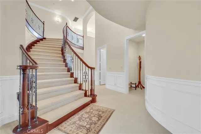 a spacious bedroom with a bed and a window