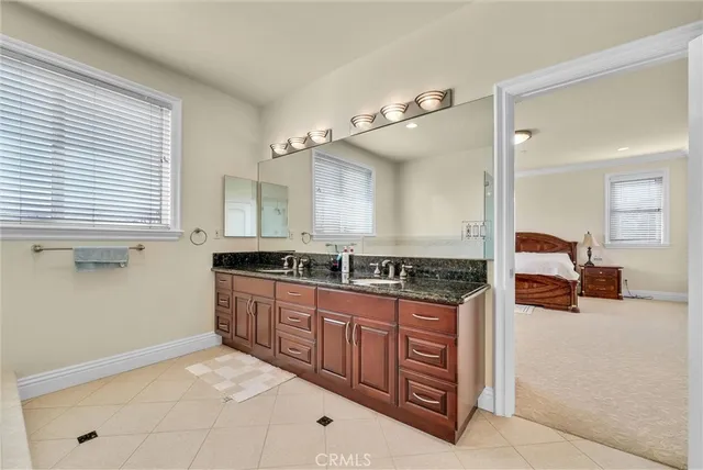 a spacious bathroom with a granite countertop sink toilet and shower