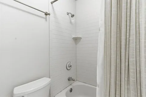 a bathroom with a toilet and shower