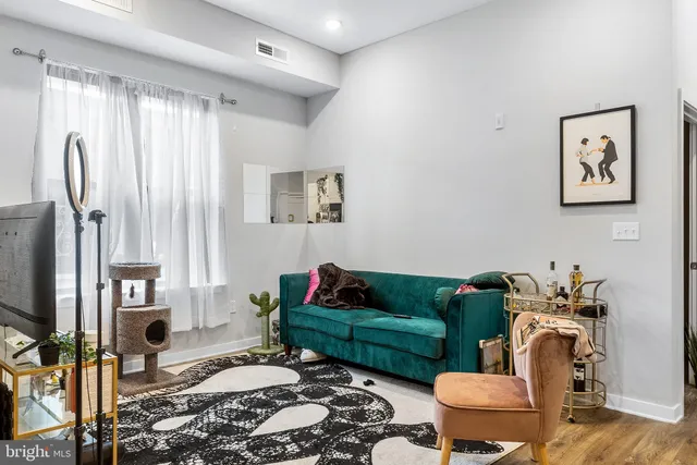 a living room with furniture rug and window