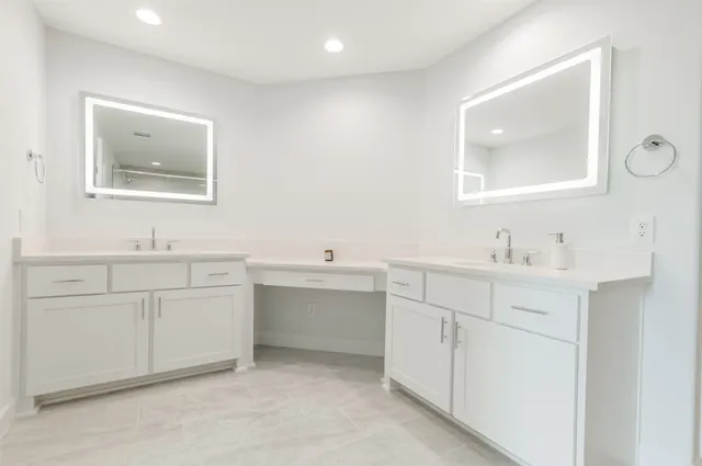 a bathroom with a double vanity sink mirror and