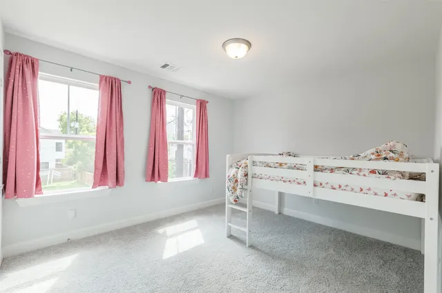 a view of bedroom with furniture and windows