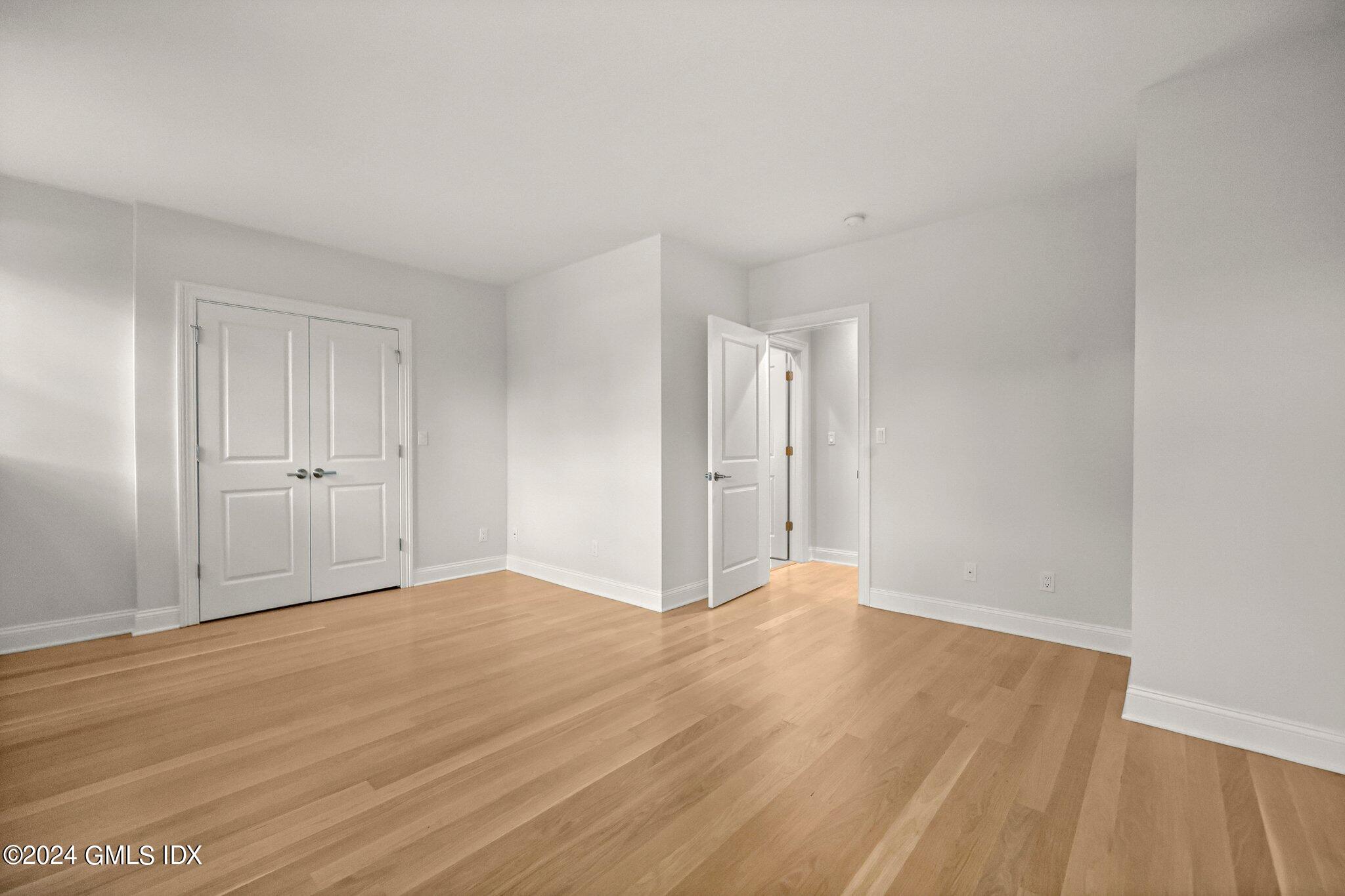 36 Arch Street, Unit 1A Greenwich, CT 06830 - Photo 15 of 19 a view of an empty room and wooden floor