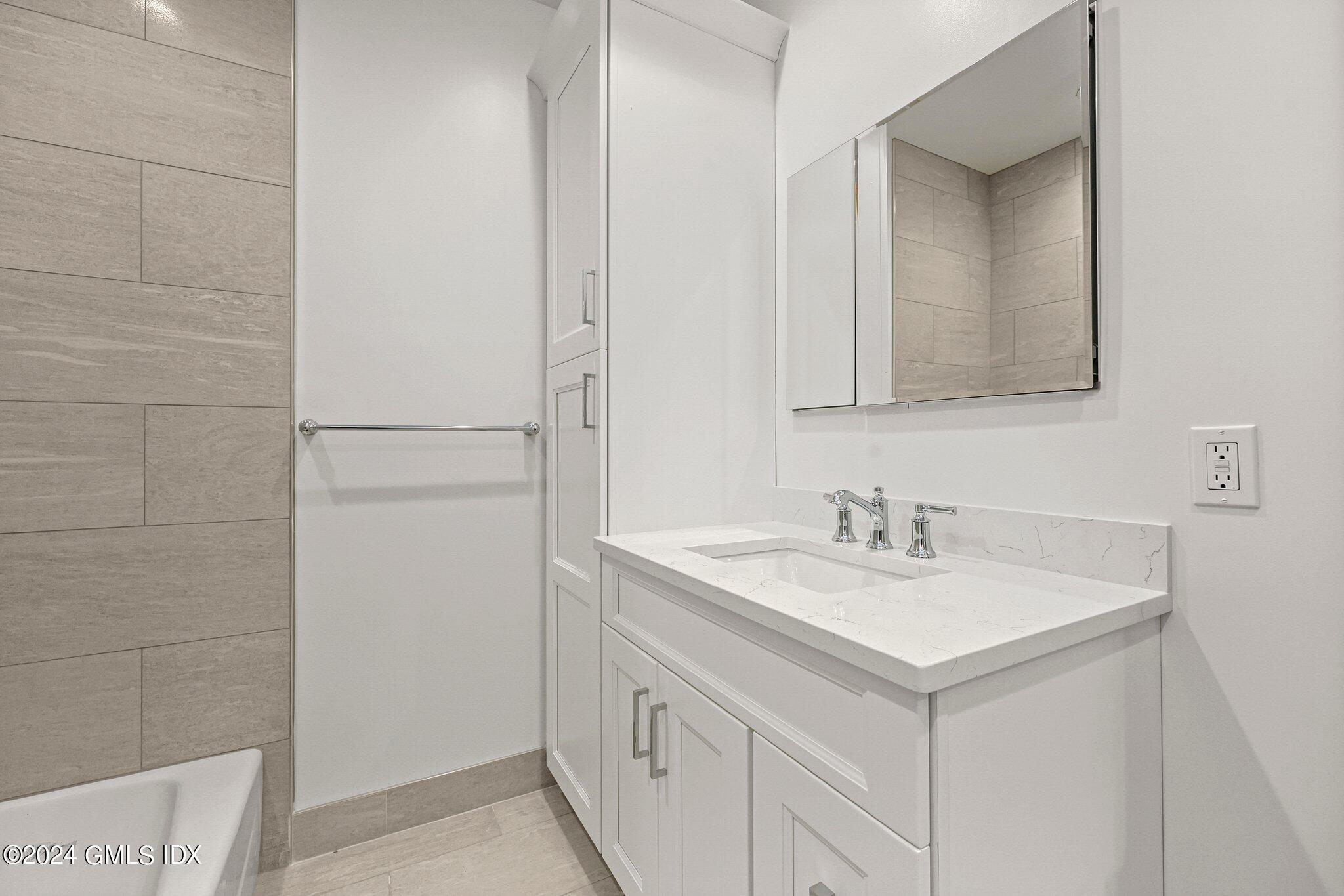 36 Arch Street, Unit 1A Greenwich, CT 06830 - Photo 16 of 19 a bathroom with a sink and a mirror