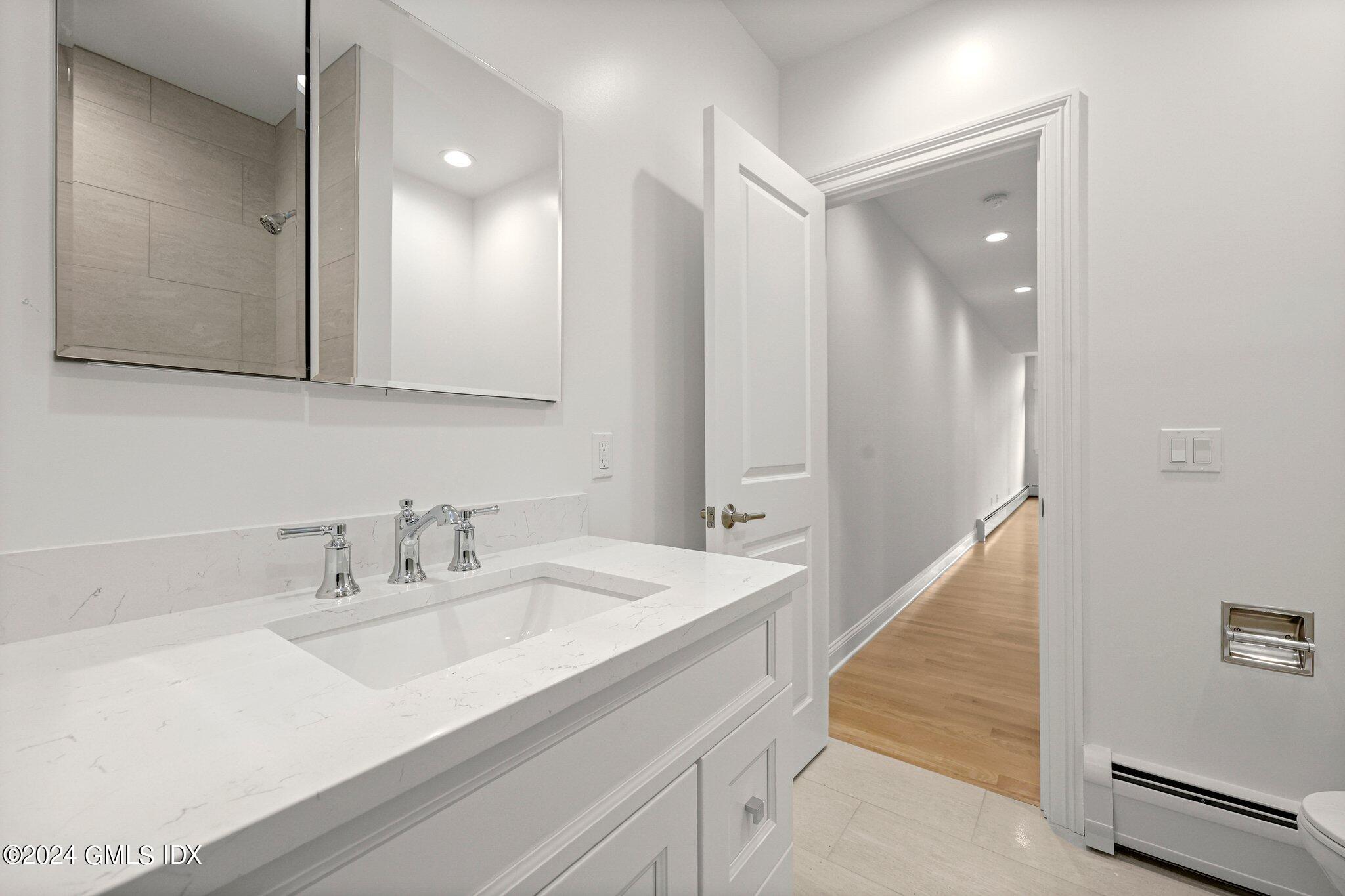 36 Arch Street, Unit 1A Greenwich, CT 06830 - Photo 17 of 19 a bathroom with a sink and a mirror