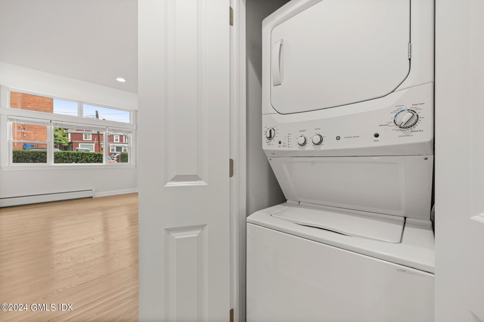 36 Arch Street, Unit 1A Greenwich, CT 06830 - Photo 18 of 19 a view of washer and dryer with bathroom in the background