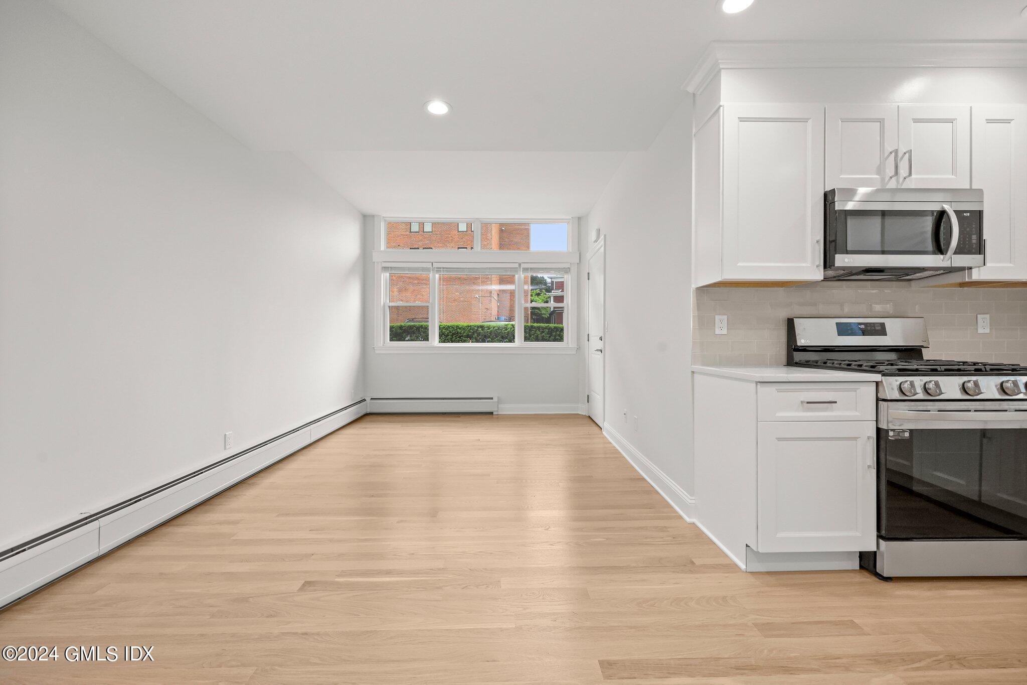 36 Arch Street, Unit 1A Greenwich, CT 06830 - Photo 9 of 19 a kitchen with stainless steel appliances a stove and a refrigerator