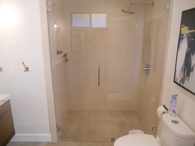 a bathroom with a toilet and a shower