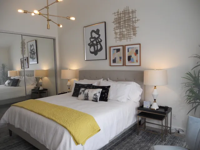 a bedroom with a bed and painting on the wall