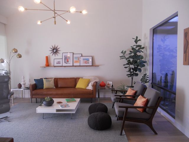 a living room with furniture and flowers