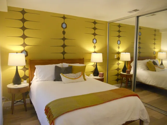 a bedroom with a bed and lamp