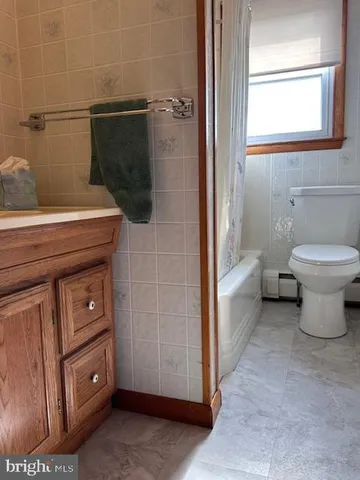 a bathroom with a toilet a sink and shower