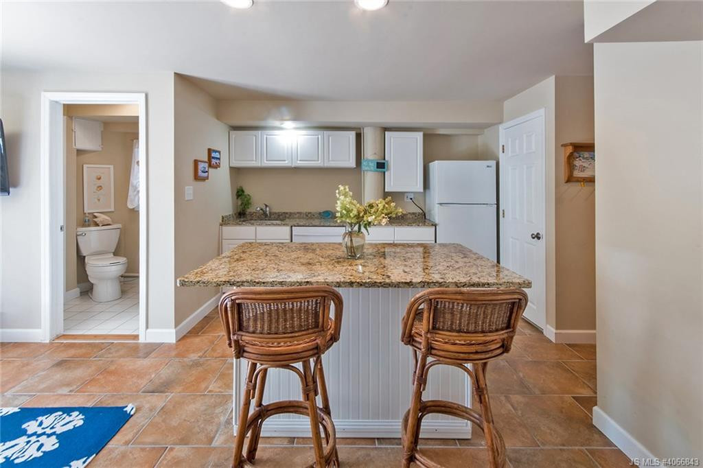 Undisclosed Address Beach Haven, NJ 08008 - Photo 23 of 36 a kitchen with granite countertop chair and a refrigerator