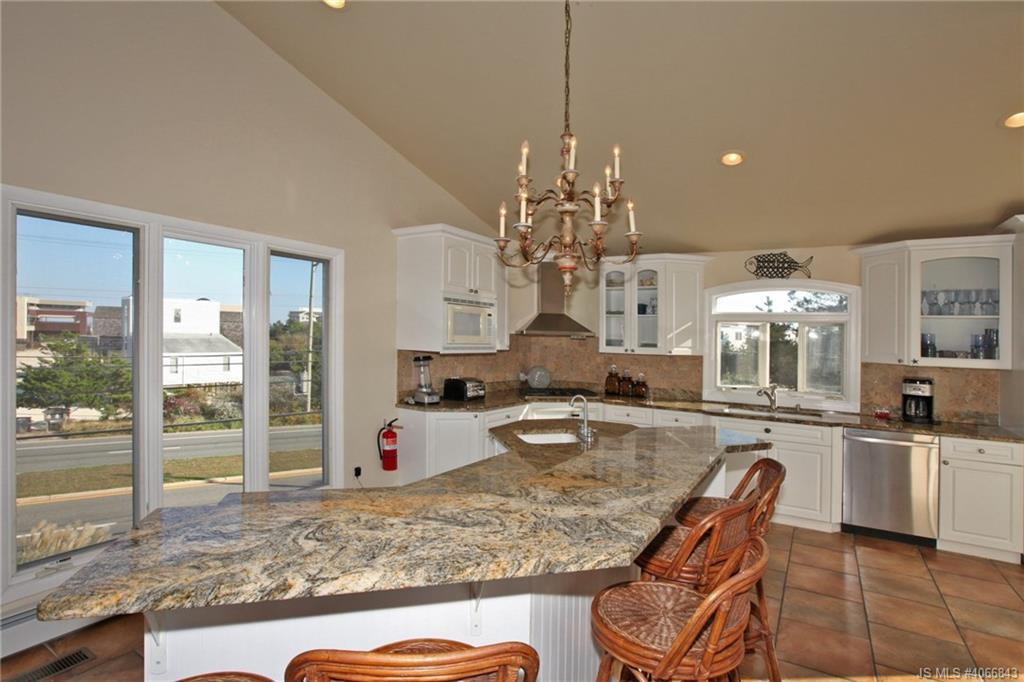 Undisclosed Address Beach Haven, NJ 08008 - Photo 5 of 36 a kitchen with sink refrigerator dining table and chairs