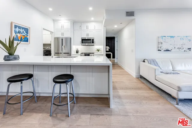 a kitchen with cabinets and chairs