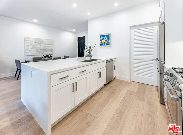 a kitchen with cabinets a sink and appliances