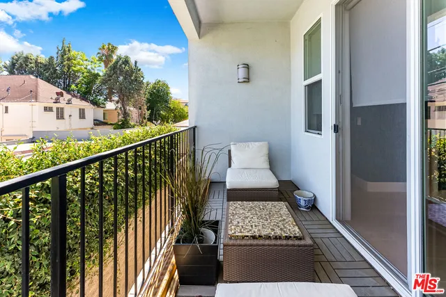 a view of a balcony with wooden floor