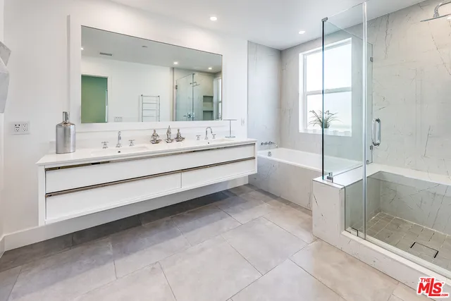 a bathroom with a bathtub a sink and a shower