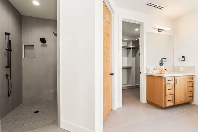a view of cabinet with mirror and shower