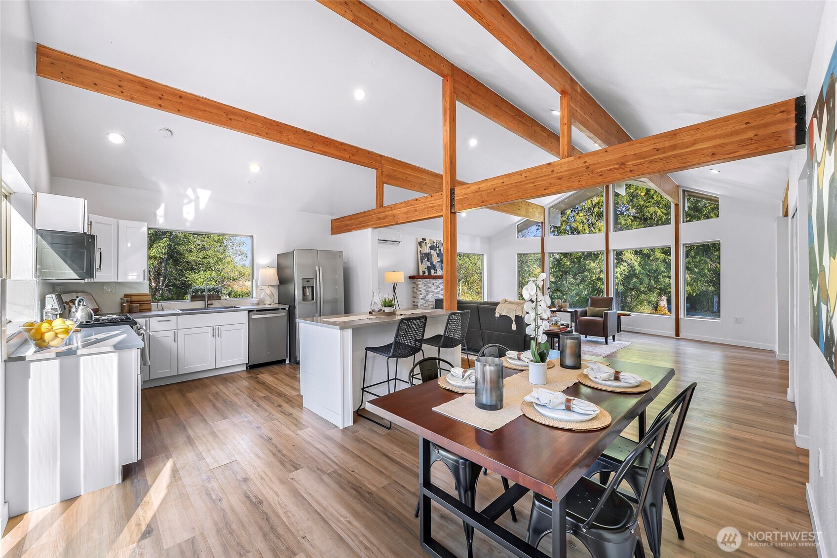 4104 Loomis Trail Road Blaine, WA 98230 - Photo 15 of 40 a dining room with stainless steel appliances kitchen island granite countertop a dining table and chairs with wooden floor