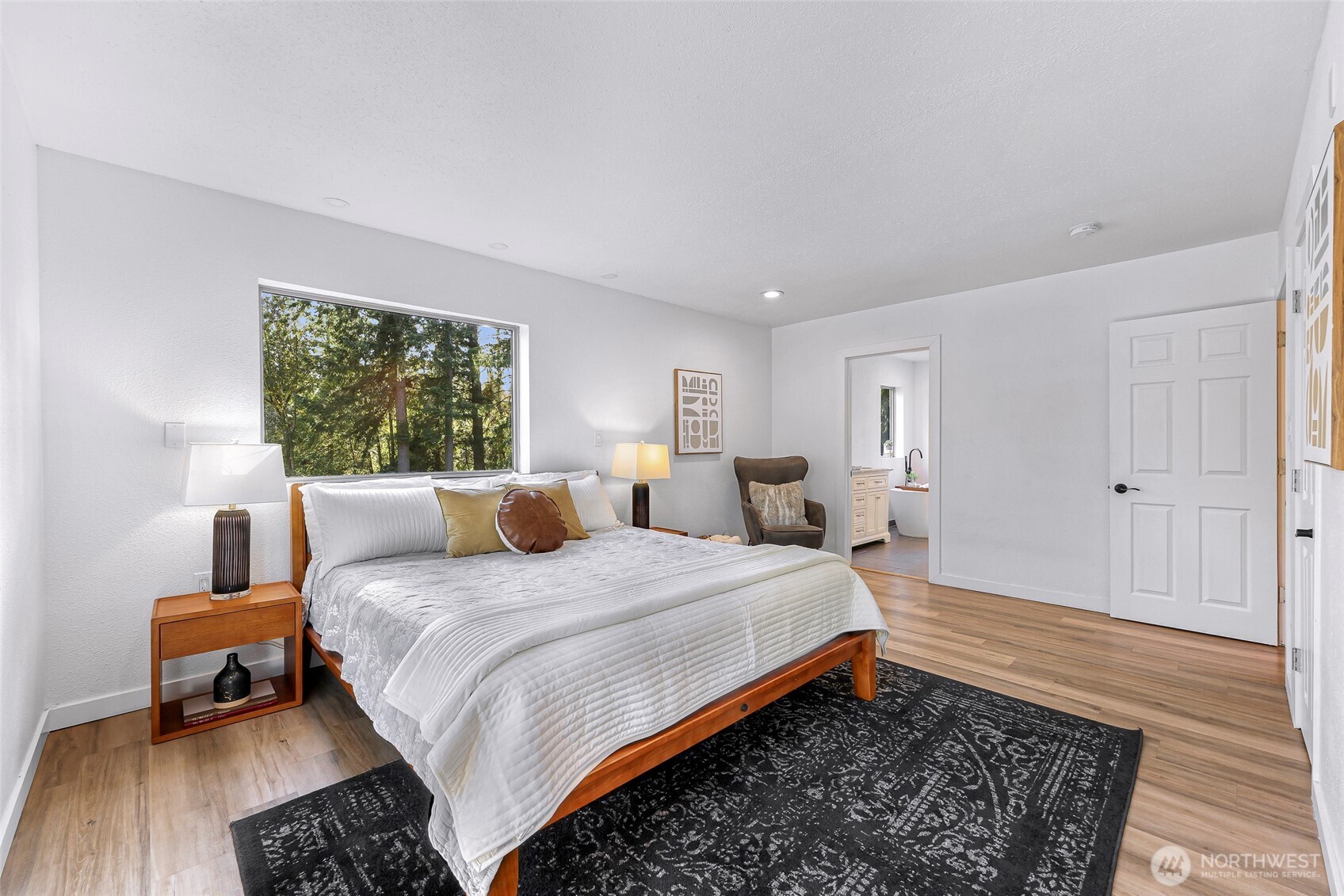 4104 Loomis Trail Road Blaine, WA 98230 - Photo 21 of 40 a bedroom with a bed and wooden floor