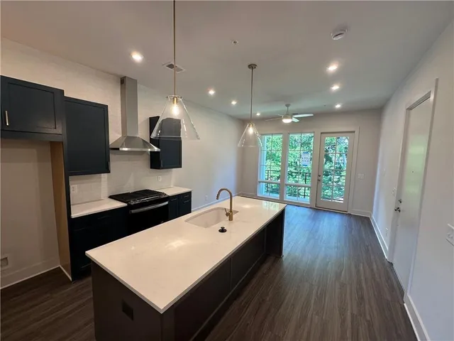 a large kitchen with kitchen island a wooden floor