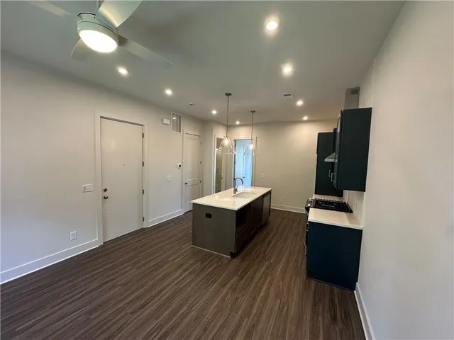 a view of kitchen with sink and refrigerator
