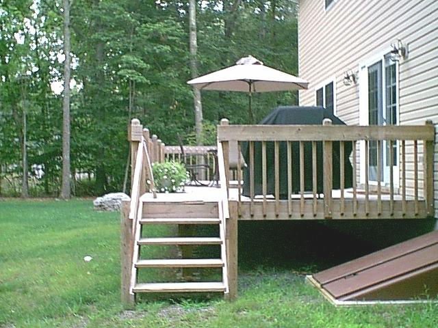 14 Antler Road Bartonsville, PA 18321 - Photo 4 of 9 a view of a deck with a table and chairs under an umbrella