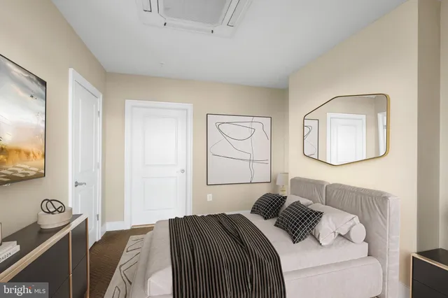 a bed sitting in a bedroom next to a window