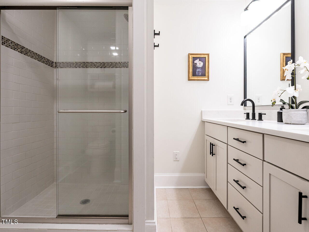 1510 Hanover Street Raleigh, NC 27608 - Photo 12 of 22 a bathroom with a double vanity sink a mirror and a shower