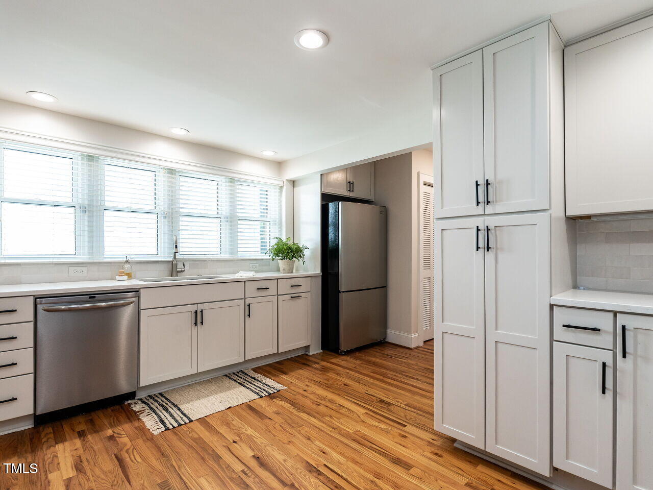 1510 Hanover Street Raleigh, NC 27608 - Photo 8 of 22 a kitchen with stainless steel appliances a refrigerator sink and cabinets
