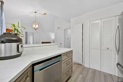 a kitchen with stainless steel appliances a sink a stove a refrigerator and cabinets