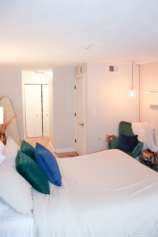 232 Canton Street, Unit 112 Randolph, MA 02368 - Photo 11 of 13 a bedroom with a bed and a dresser