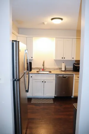a kitchen with a refrigerator sink and cabinets