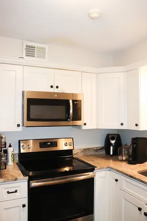 a kitchen with a stove and a microwave