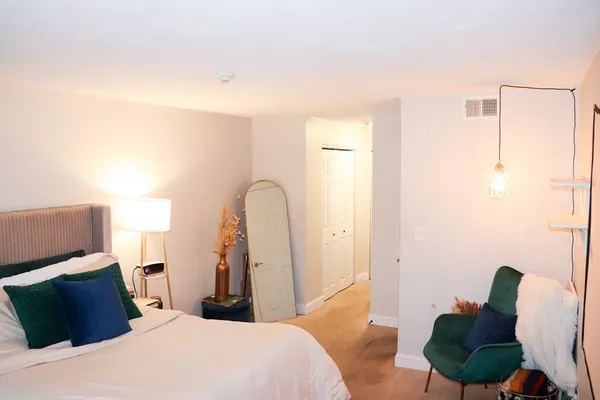 a bedroom with a bed and a mirror
