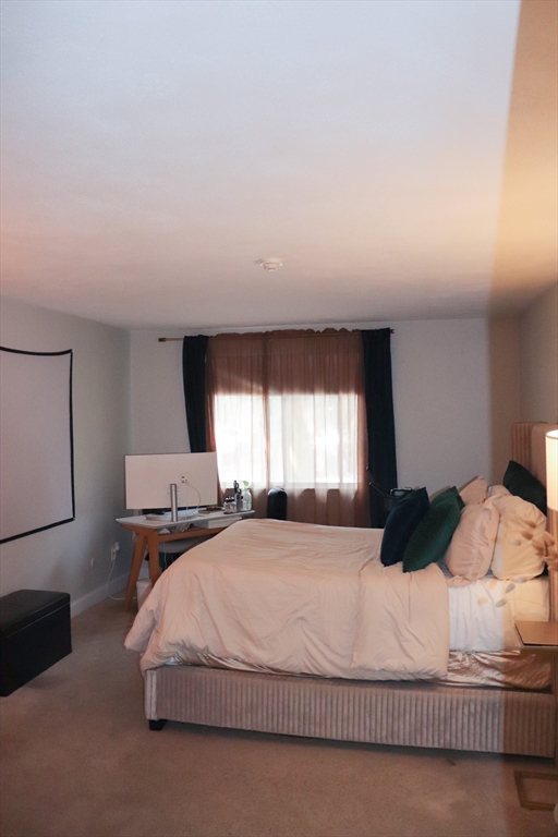 232 Canton Street, Unit 112 Randolph, MA 02368 - Photo 6 of 13 a bedroom with a bed and window