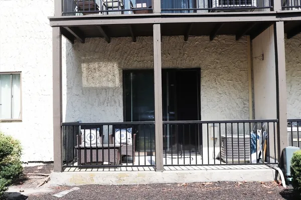 a view of a balcony with a fireplace and wooden floor