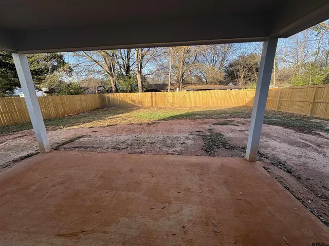 a view of a yard with a tree