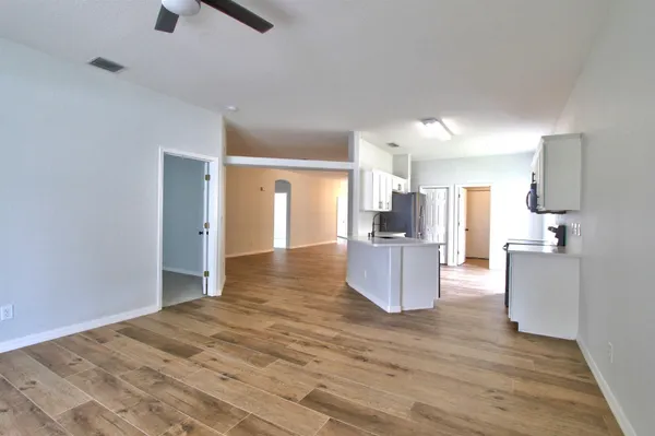 a view of kitchen and utility room with wooden floor