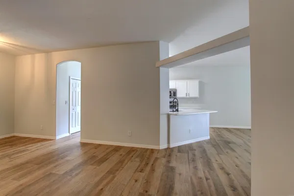 a view of a room with wooden floor and a sink