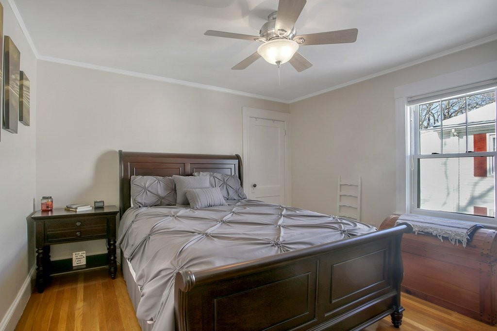 14 Russell Road, Unit 14 Winchester, MA 01890 - Photo 12 of 18 a bedroom with a bed and a chandelier