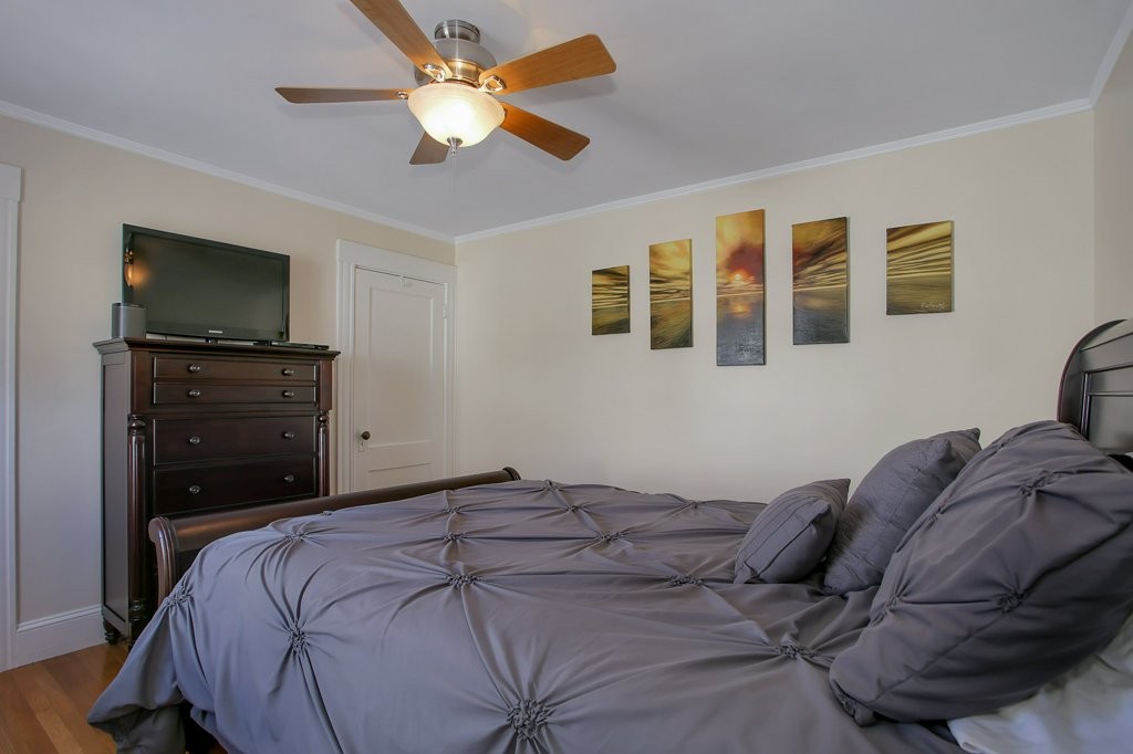 14 Russell Road, Unit 14 Winchester, MA 01890 - Photo 13 of 18 a bedroom with a bed dresser and a flat screen tv