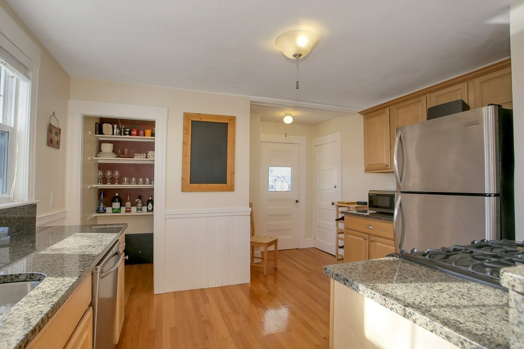 14 Russell Road, Unit 14 Winchester, MA 01890 - Photo 5 of 18 a kitchen with granite countertop a refrigerator a stove and a sink
