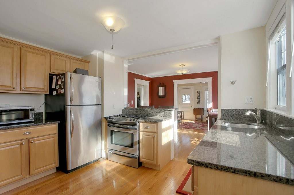 14 Russell Road, Unit 14 Winchester, MA 01890 - Photo 8 of 18 a kitchen with kitchen island a stove a sink and a refrigerator